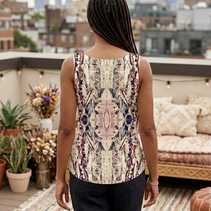 Person wearing a patterned sleeveless top on a rooftop with cityscape in the background