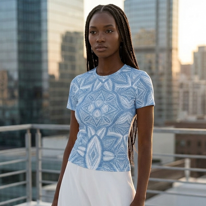 Woman in a blue patterned top and white skirt on a rooftop with city skyline in the background